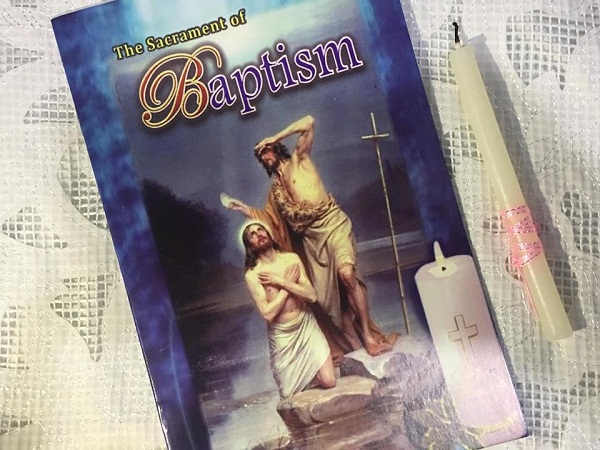 Baptism booklet which we read and the candle I lighted during the baptismal ceremony. Kept them as souvenir.